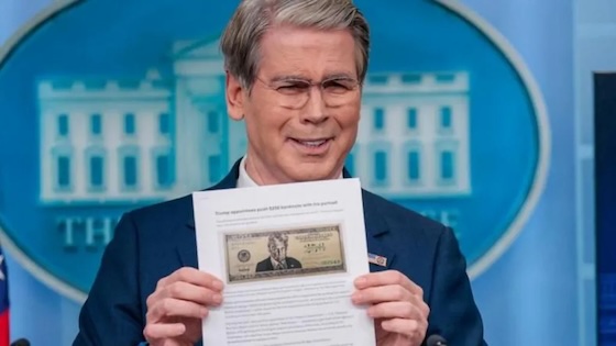 Treasury Secretary Scott Bessent holds up a news article with a mock-up of a possible Trump bill